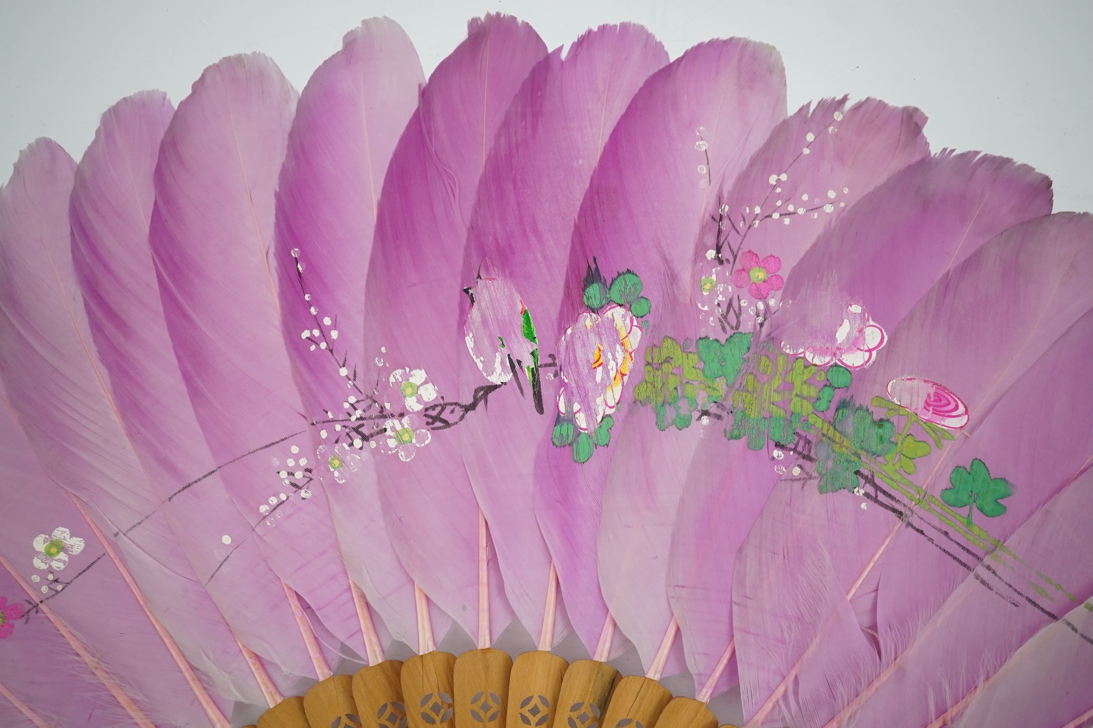 Three 19th century Chinese feather fans: One a carved bone brise black feather fan together with two similar carved sandalwood feather fans, two fans have hand painted decoration on the feathers both sides, the pink feat